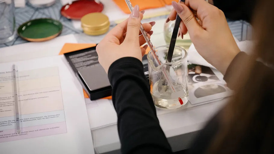 Person measuring liquid in a laboratory setting.