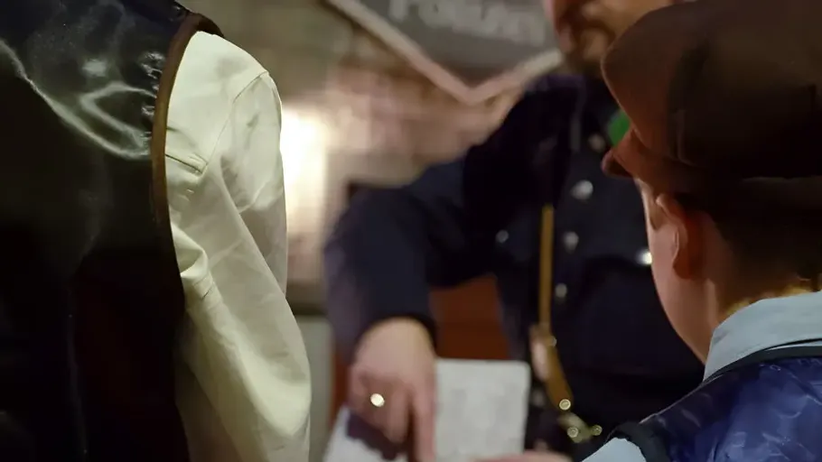 People in vintage clothing at historical event.