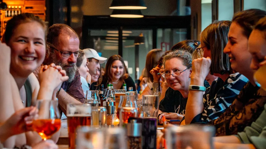 People enjoying drinks at a lively bar.