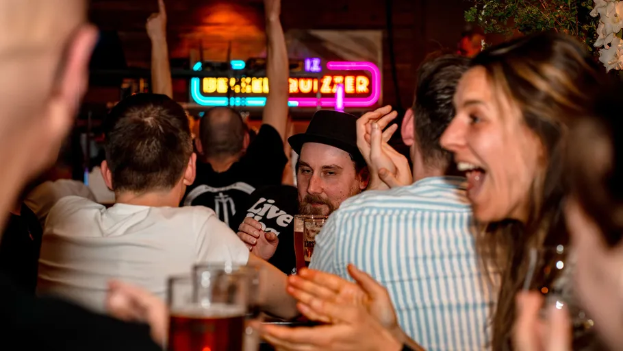 People enjoying drinks at a lively bar.
