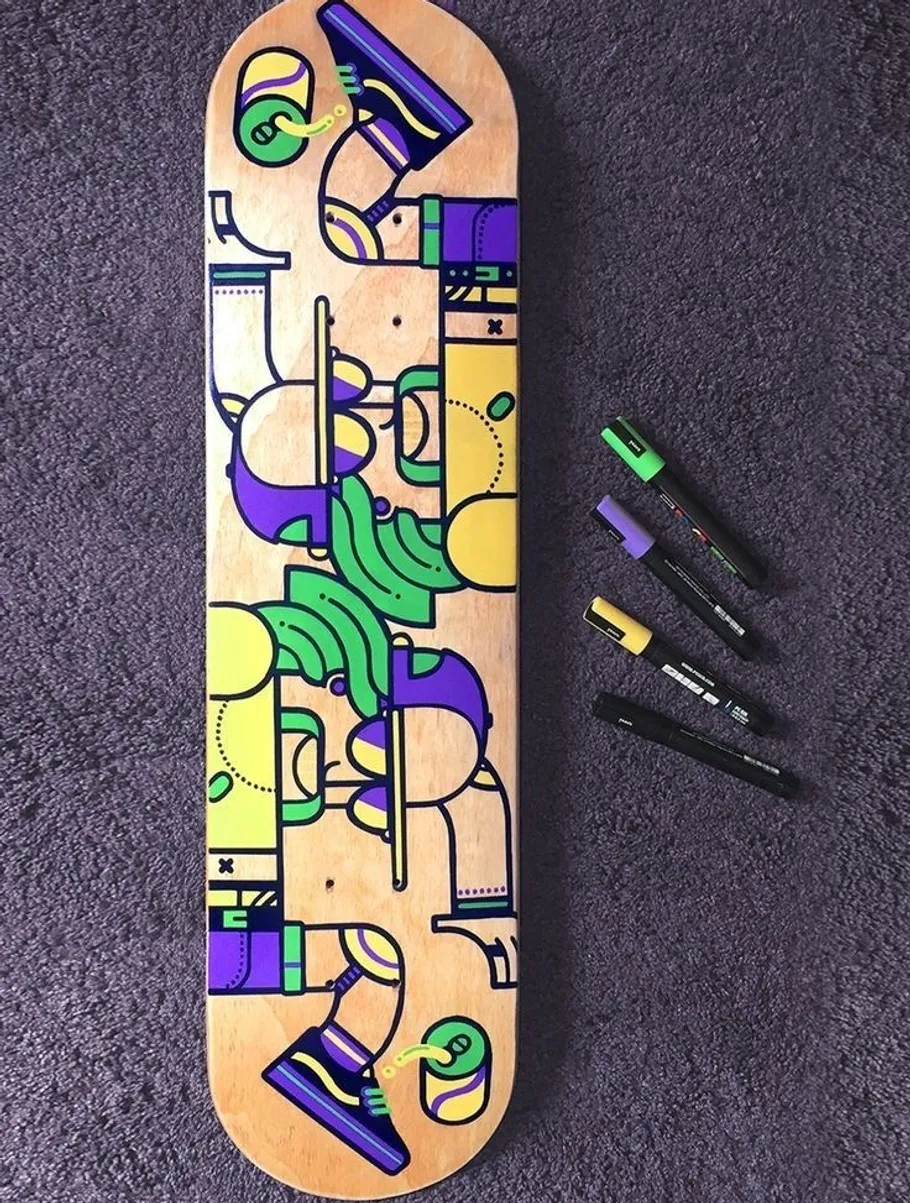Colorful skateboard with markers on carpet.