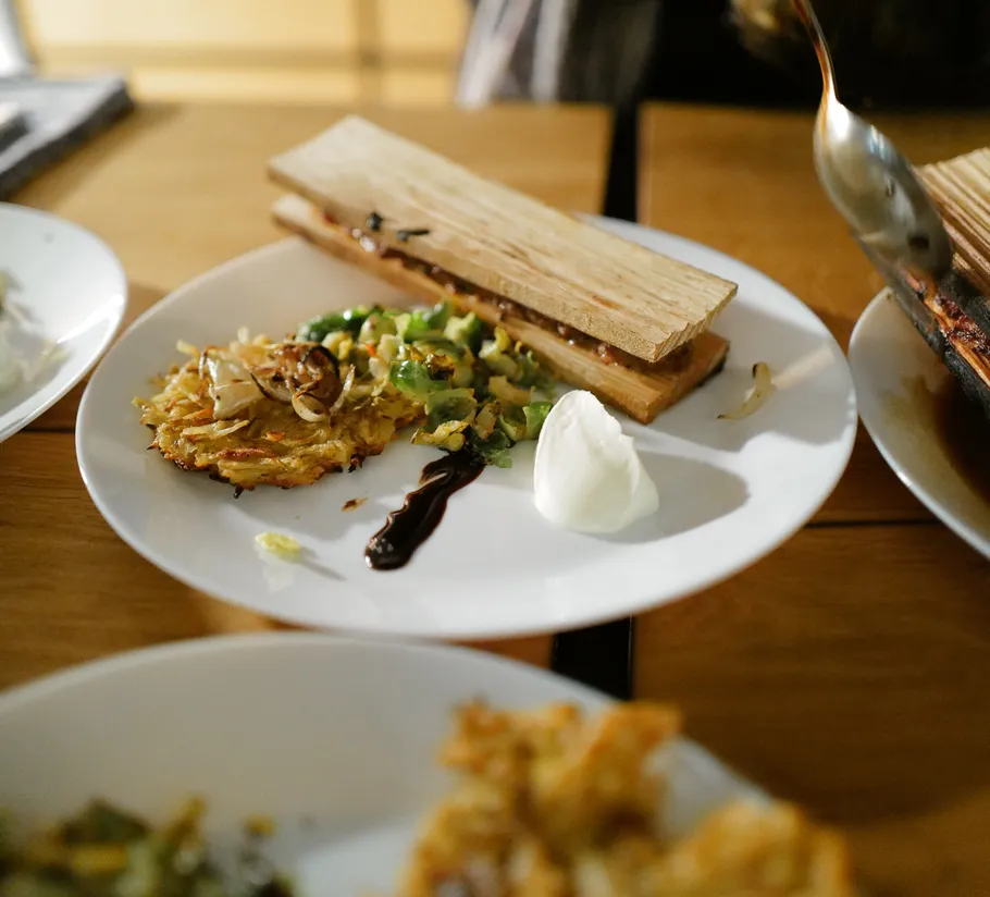 Plate with gourmet dish and sauce on table.