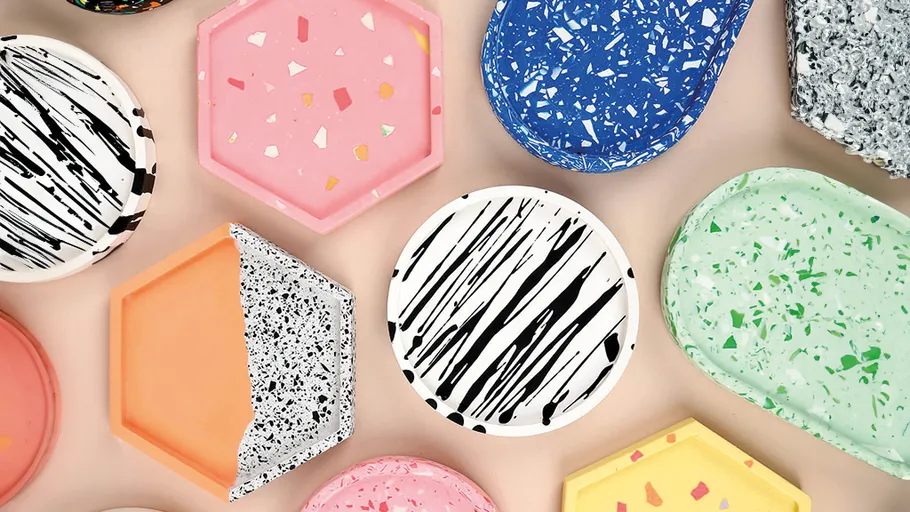 Colorful terrazzo coasters arranged on a beige surface.