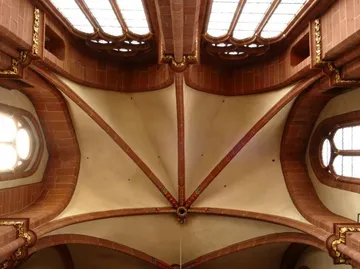 Ceiling with ornate red stones and skylights.