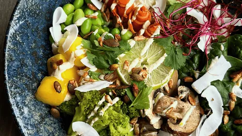 Colorful salad with vegetables and seeds in a bowl.