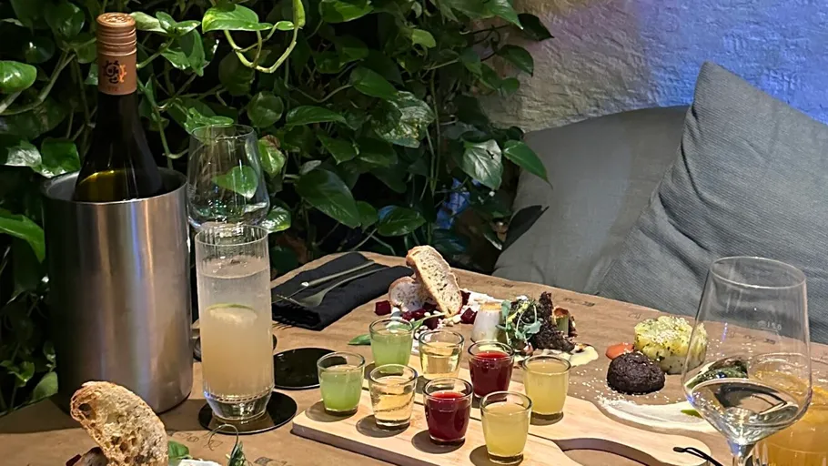 Colorful drinks and snacks on wooden table.