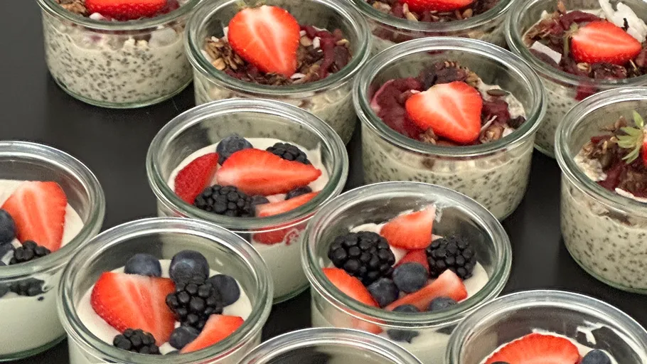 Small jars of yogurt with fresh berries on top.