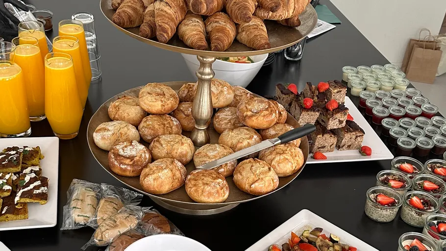 Pastries and food on a buffet table.