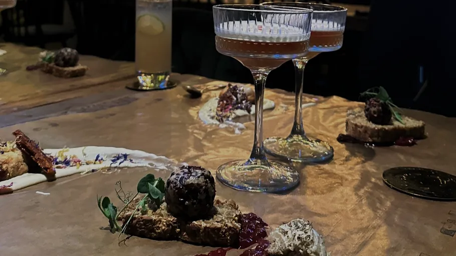 Gourmet dishes and cocktails on a table.
