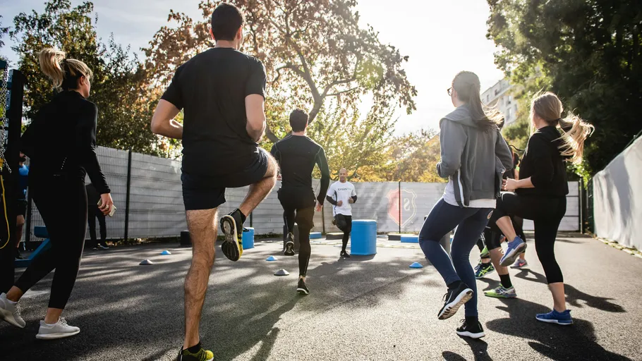 People exercising outdoors in a group workout.