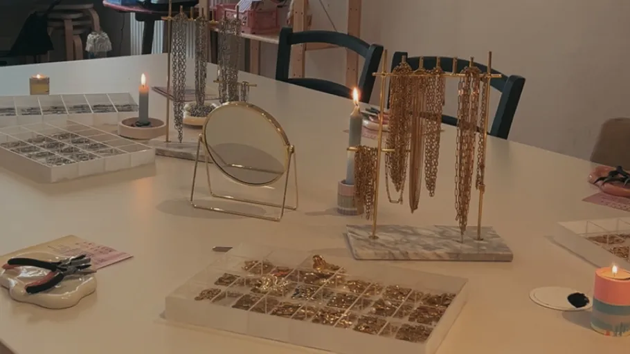 Jewelry making table with tools and materials.