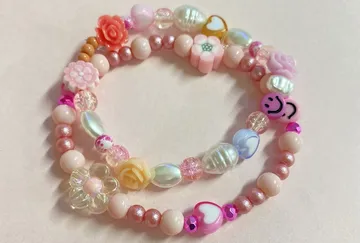 Colorful beaded bracelets on light surface.