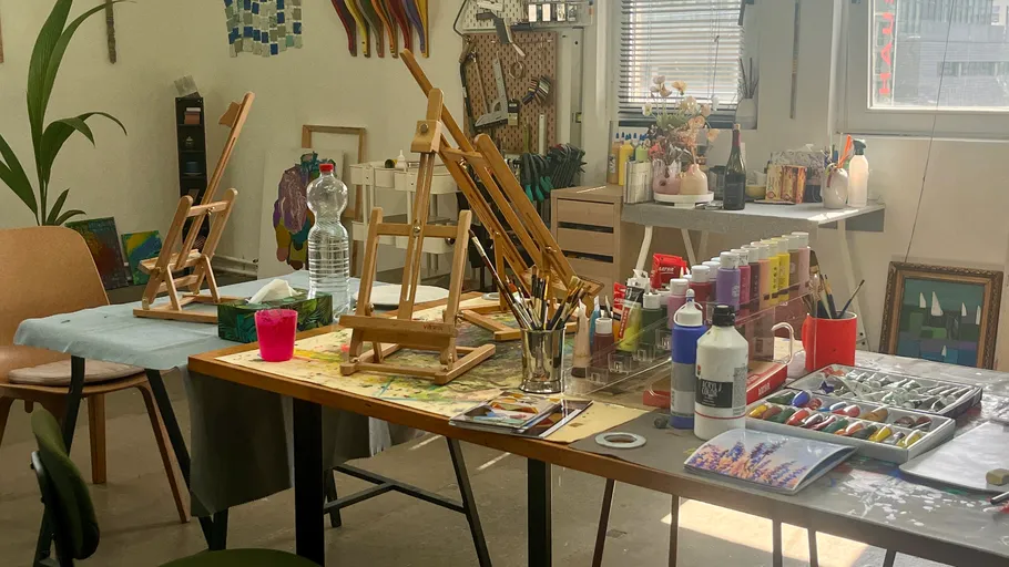 Art studio with easels on tables.