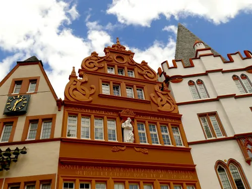 Historic building with ornate decorations and a clock.