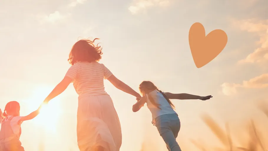 Three people running in a sunny field.