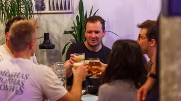Group toasting with drinks at a table.