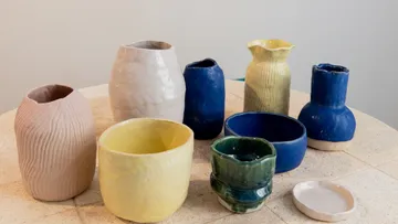Colorful ceramic pots on a round table.