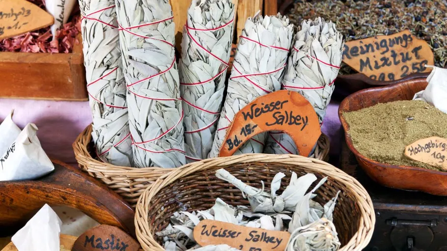 White sage bundles displayed on market stall.