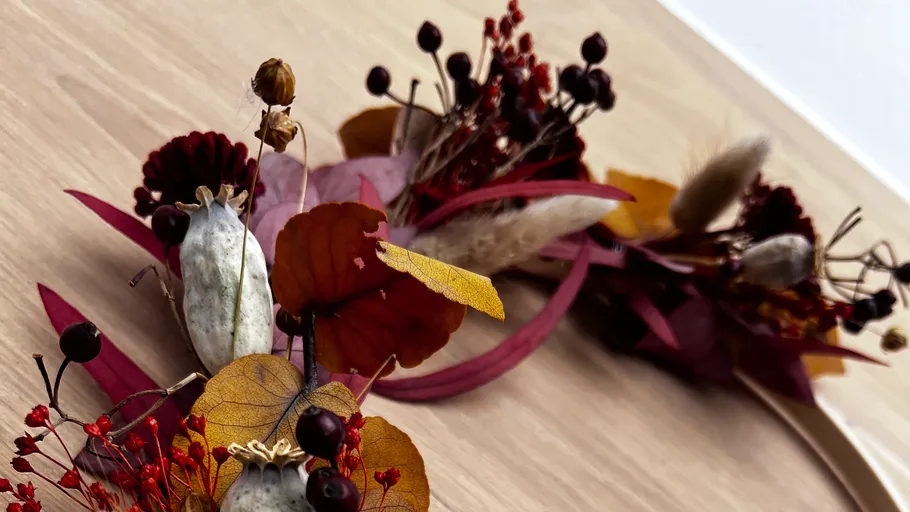 Dried flowers arranged on wooden surface.