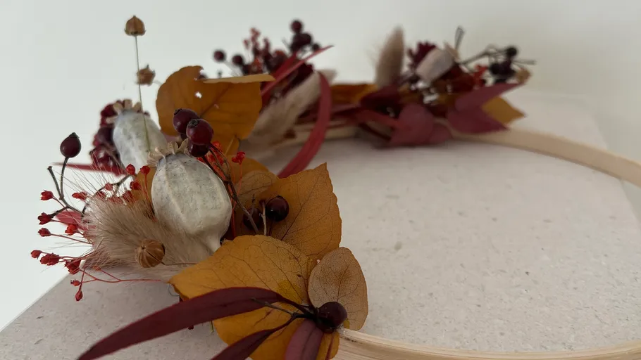 Dried flower wreath on a light surface.