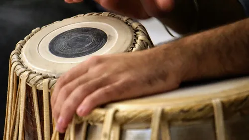 Hands playing a traditional Indian drum.