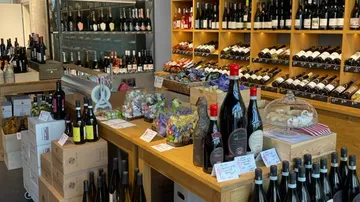 Wine bottles displayed on shelves in store.