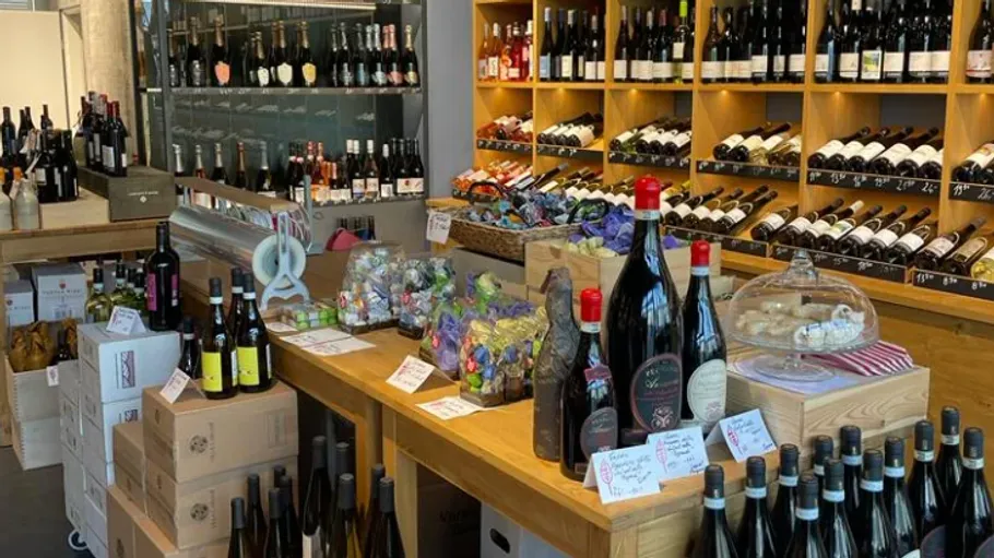 Wine bottles displayed on shelves in store.
