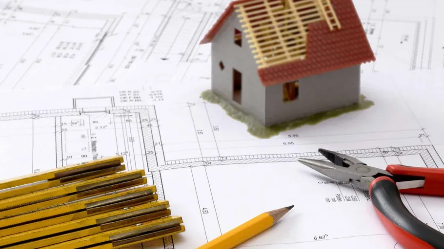 Mini house model on architectural plans.