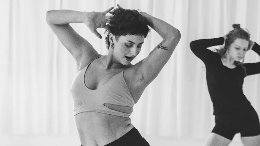 Two women dancing in a studio environment.