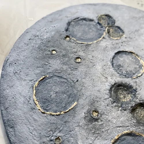 Textured surface with circular indentations.