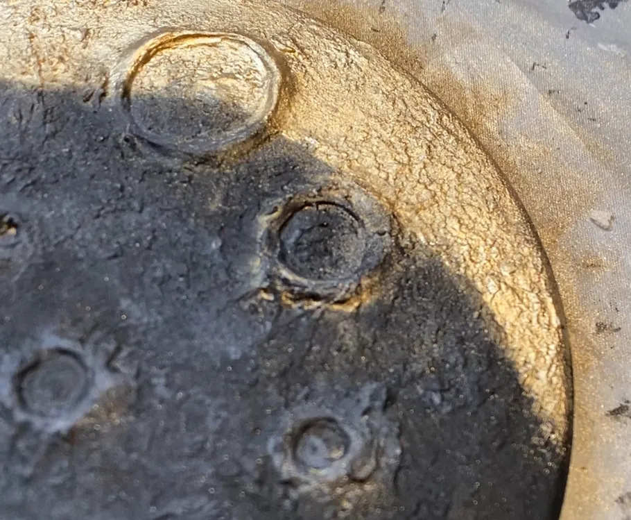 Close-up of textured surface with circular imprints.