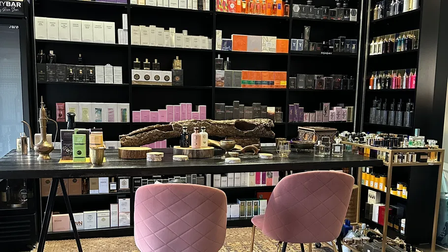 Perfume bottles displayed on shelves and table.