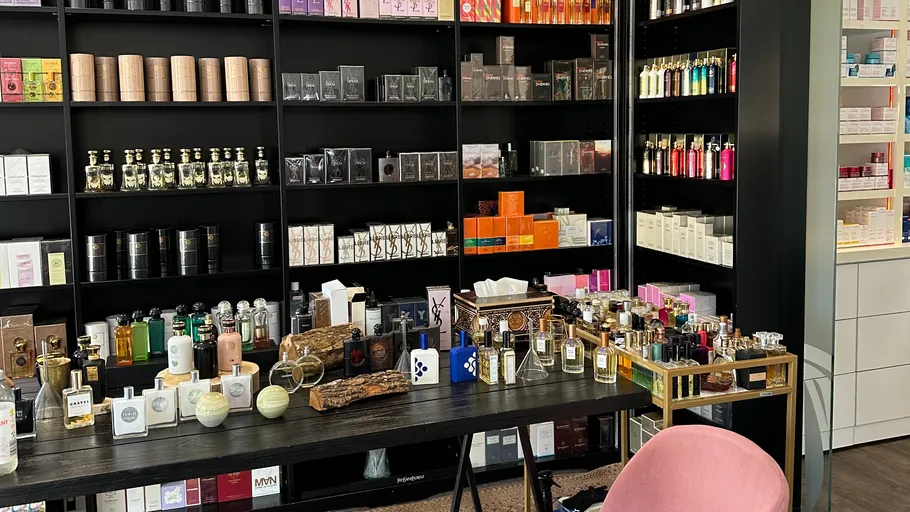 Perfume shop with shelves and table display.