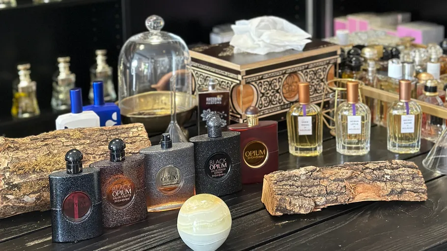 Perfume bottles displayed on a wooden table.