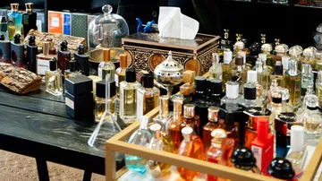 Various perfumes displayed on a table.