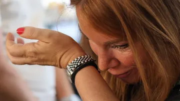 Woman smells wrist in close-up setting.