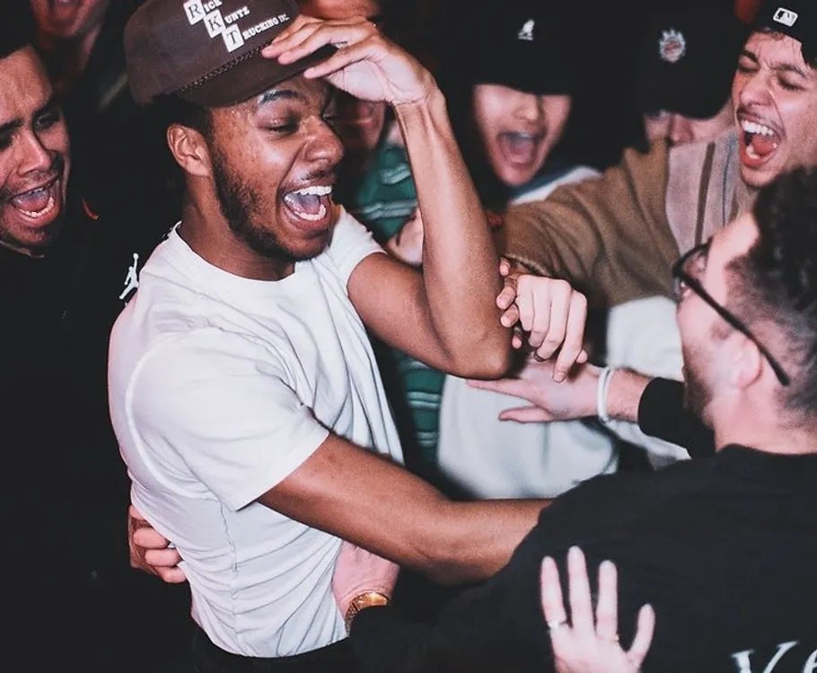 Group of friends celebrating joyfully indoors.