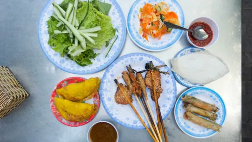 Vietnamese dishes on a metallic table.