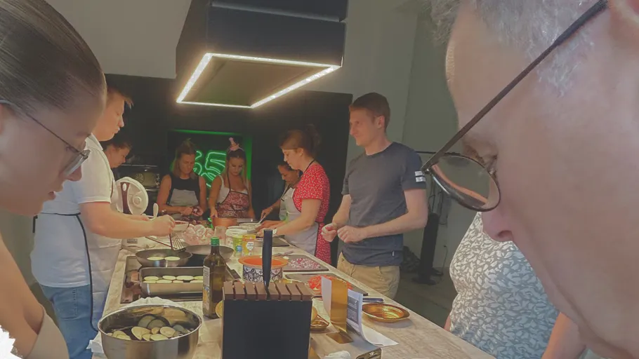 Group cooking in a modern kitchen.