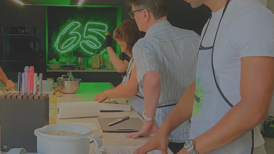 People cooking in a modern kitchen studio.