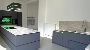 Modern kitchen with central island and appliances.
