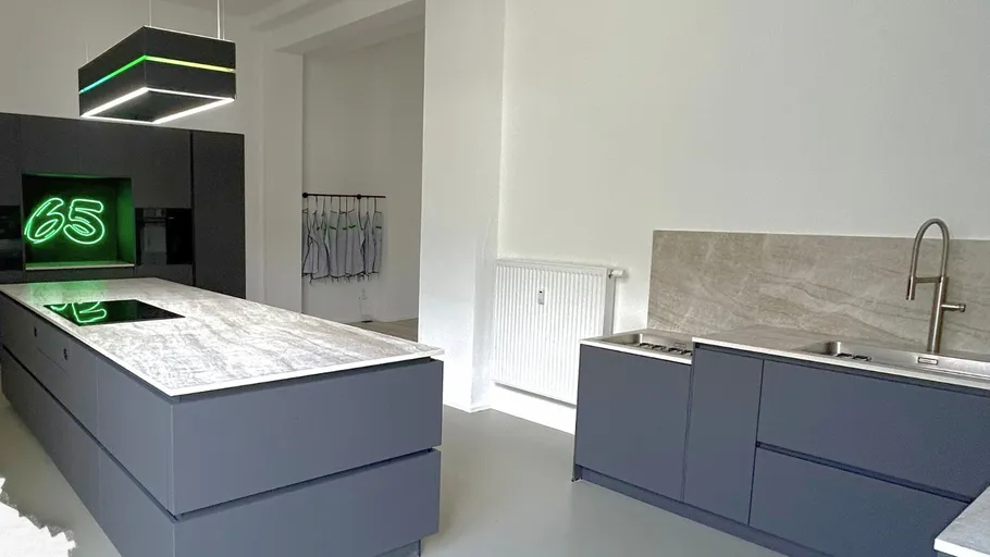 Modern kitchen with central island and appliances.