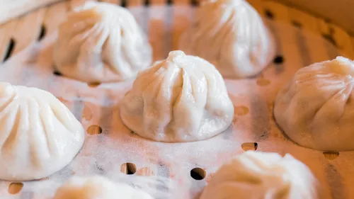 Steamed dumplings in a bamboo steamer.