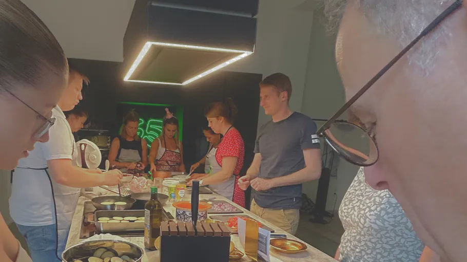 Group cooking lesson in a kitchen setting.