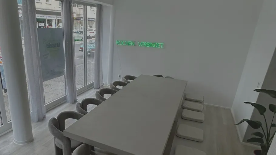 Modern dining room with large table and chairs.