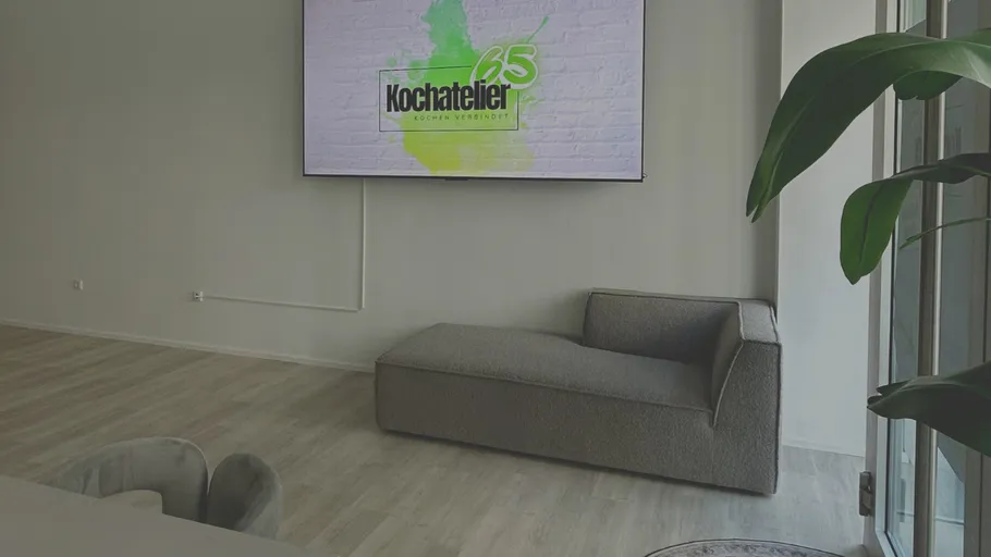 Modern room with sofa and large screen.