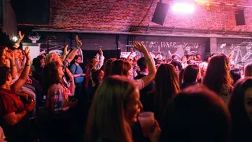 Crowd of people enjoying a concert indoors.