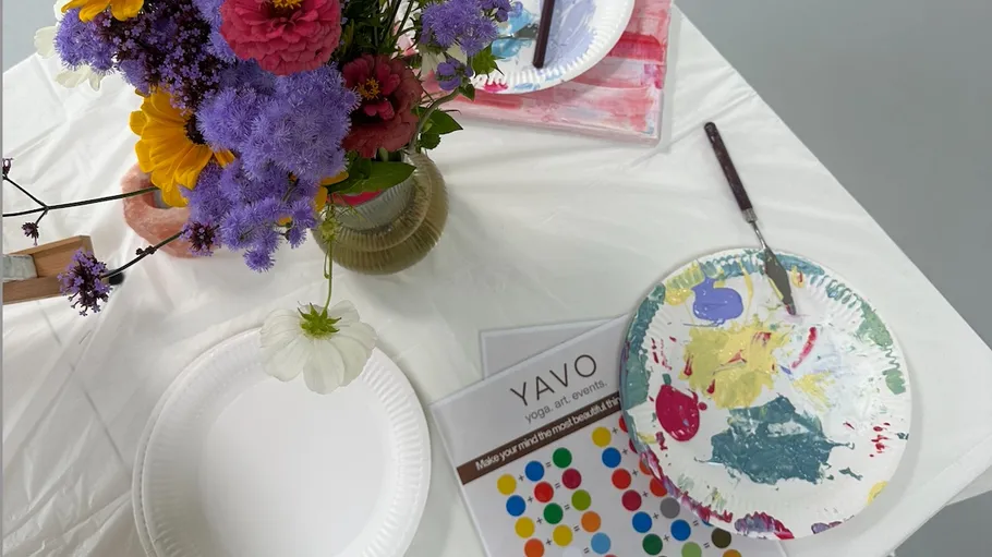 Paint splatters on paper plates with colorful flowers.