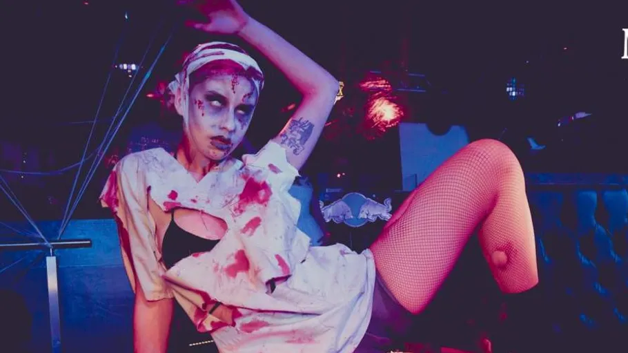 Person in zombie costume in a nightclub.