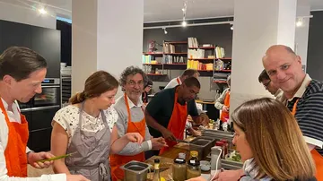 People cooking together in a modern kitchen.